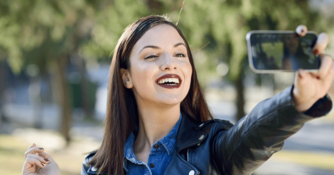 How do people react when you post a selfie in social media?